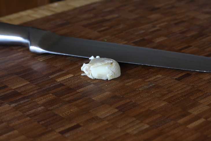 To easily remove garlic peel, lay your chef's knife flat down on the clove and (carefully) give it good whack with the heel of your hand. 